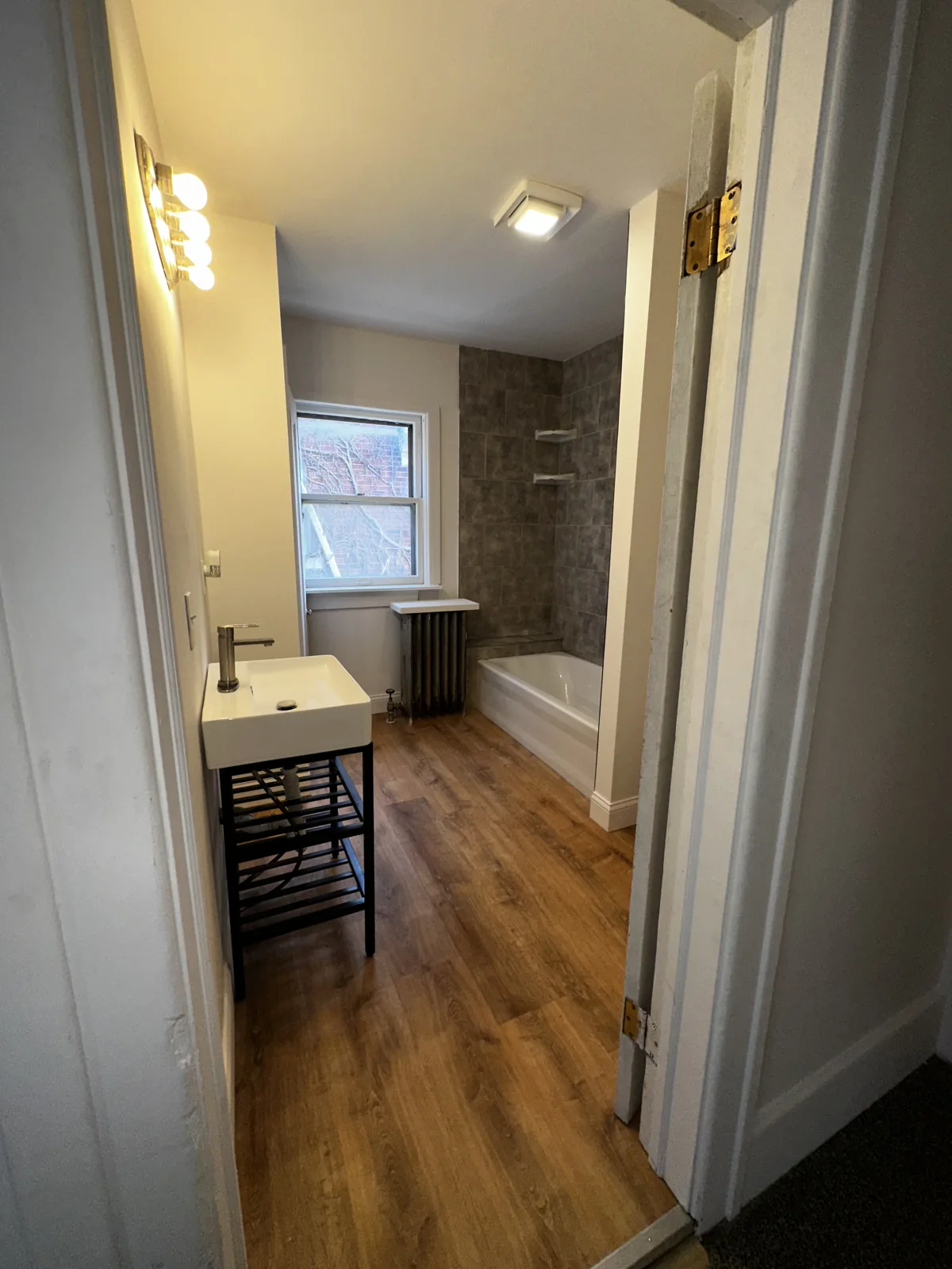 Bright bathroom refresh with tile walls and window, West Bloomfield